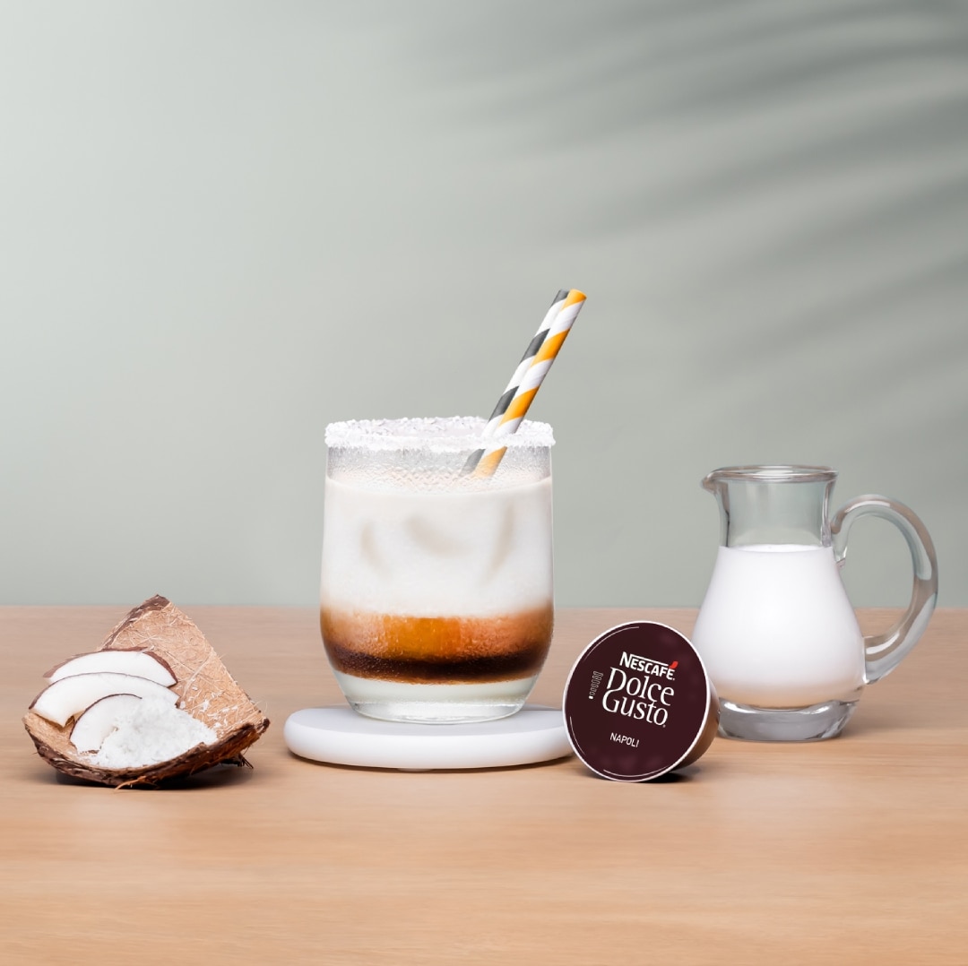 iced espresso next to a coffee capsule